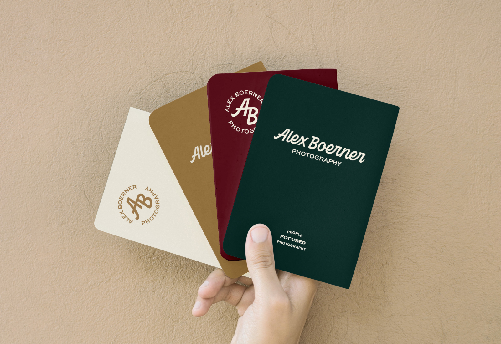 Hand holding four pocket notebooks with branding Alex Boerner Photography | Custom Lettered Logotype