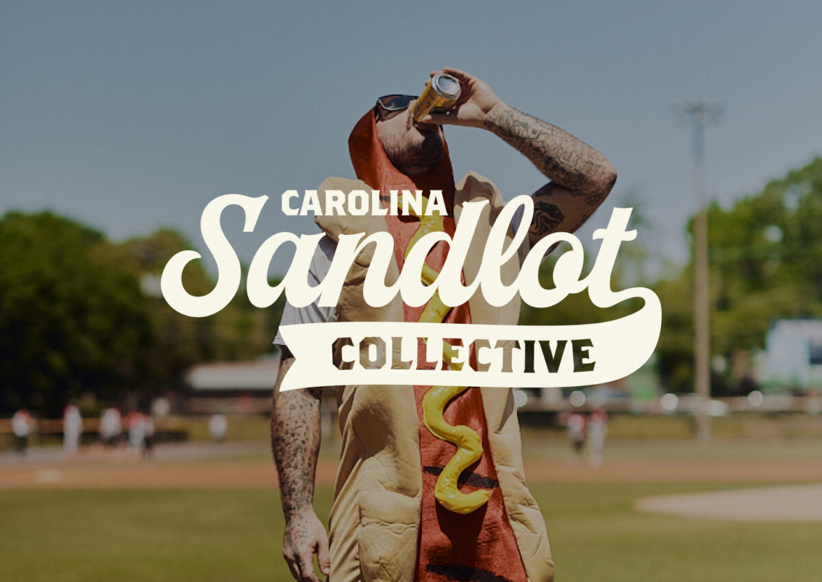 Primary Logo overtop a photo of a hotdog drinking a beer | Carolina Sandlot Collective