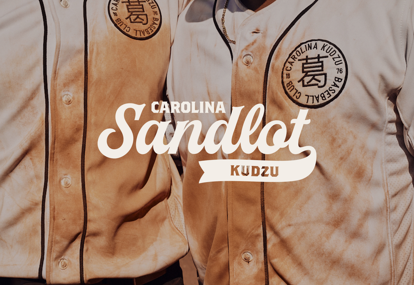 Kudzu Logo Variation overtop a photo of game worn jerseys | Carolina Sandlot Collective